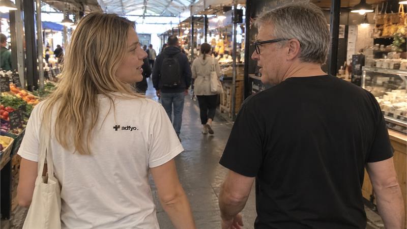 The Adfyo crew continuing a conversation through a covered market